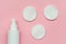 Makeup removing, white facial cotton pads and bottle of micellar water, woman skin and body care product isolated on pastel pink b