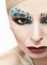 Makeup with turquoise stones.