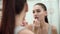 Makeup. Woman Applying Liquid Lipstick On Lips At Bathroom