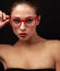 makeup woman in red eyes glasses