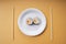 Maki roll sushi on paper plate on dinner desk