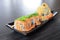 Maki sushi roll made of salmon top with wakame seaweed - Japanese food