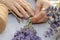 Making a bouquet of fresh lavender. Step by step photo of a woman\'s hand tying a bunch of lavender