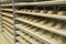 Making bread in bakery. Uncooked bread dough on a rack ready for baking in oven. Prepared raw bread dough shaped into loaves on sh