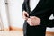 Making business look good. Close-up of man buttoning his jacket while standing against white background