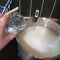 Making cheese ricotta with your own hands. Step-by-step photos of the process. Pouring vinegar into hot whey to produce