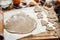 Making christmas gingerbread cookies. Raw dough in shape of man,christmas tree, star, deer and wooden rolling pin, anise, ginger,