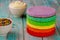 Making colorful rainbow layered birthday cake with cream