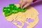 Making cookies in the form of various figures. Woman confectioner with the help of plastic molds forms from the dough cookies for