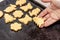 Making cookies in the form of various figures. Woman confectioner puts on a frying pan cookies  for baking