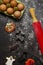 Making cookies for halloween. Rolling pin, whisk, ready-made cookies on a dark background