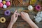 Making crochet amigurumi donuts. Toy for babies or trinket.  On the table threads, needles, hook, cotton yarn. Handmade gift.