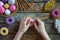 Making crochet amigurumi donuts. Toy for babies or trinket.  On the table threads, needles, hook, cotton yarn. Handmade gift. DIY