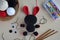 Making crochet voodoo rabbit. Toy for Halloween.  On the table threads, hook, cotton yarn. Handmade gift. Mystic, occult, horror