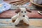 Making crochet white dog. Toy for babies or trinket.  On the table threads, needles, hook, cotton yarn. Handmade gift. DIY crafts