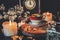 Making a cup of tea in witch`s kitchen. A vintage red white and gold colored teacup placed on a wooden platform on a black table