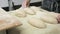 Making dough by male hands at bakery