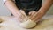 Making dough by male hands at bakery