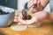 Making dumplings filled with sour cherry with sugar