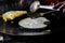 Making of egg roll on a hot frying pan with oil and paratha and salad