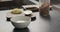 Making granola with mango in white bowl on kitchen