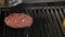 Making and grilling hamburger buns with sesame on coal grill. Preparing roasted food on barbecue BBQ grill in outdoor