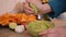 Making guacamole - closeup on hands squeezing lime