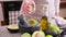 making guacamole - woman squeezing lime juice into marble mortar with halved peeled Avocados