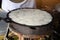 Making Kanom Krok, Coconut milk dessert with flour and sugar on a hot stove, Thai Asian food