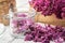 Making lilac sugar. Lilac flowers and sugar in a preserving jar. Blossom Syringa on background