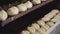 Making a loaf of bread in a bakery. Many loaves of bread in the oven.