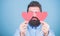 Making man feel loved. Man bearded hipster with heart valentine card. Celebrate love. Guy attractive beard and mustache