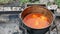 Making meal outdoor on open fire in cauldron plov pilaf