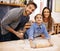 Making memories as a family. Portrait of a happy family of three baking together in the kitchen.