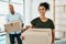 Making the move to a bigger and better home. Portrait of a couple young carrying boxes while moving house.