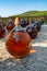 Making of natural sweet dessert muscat liqueur white wine outside in big round glass antique demijohn bottles in