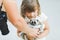 Making photo of exotic animals. Little girl with lory lemur