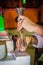 Making a picture of sand in a bottle. Male hands closeup. Hurghada, Egypt.