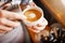 Making pictures. A cropped shot of an unrecognizable barista pouring frothy milk into a cup of hot coffee turning it