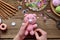 Making pink pig. Crochet toy for child. On table threads, needles, hook, cotton yarn. Step 2 - to sew all details of toy. Handmade