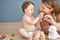 Making playtime fun and engaging. Shot of an adorable baby girl and her mother playing with wooden blocks at home.