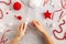 Making pom-poms from red and white threads. Ideas of Christmas decoration diy with kids