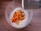 Making a pumpkin pie. Putting the vegetable puree in a glass dough bowl.