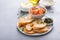 Making salmon and cream cheese bruschetta with dill and capers