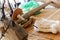 Making sheep wool thread by traditional spinning wheel , Thailand