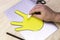 Making the simplest Easter bunny with your own hands a person bends the fingers cut out of cardboard with his hands making paws