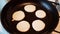 Making small pancakes on frying pan