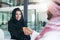 Making success happen with strong negotiation skills. a young muslim businesswoman shaking hands with an associate in a