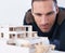 Making sure that every detail is perfect. Close-up of a male architect viewing a scale model.