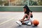 Making sure my laces are tied tight. an attractive young sportswoman sitting on the court and tying her shoelaces before